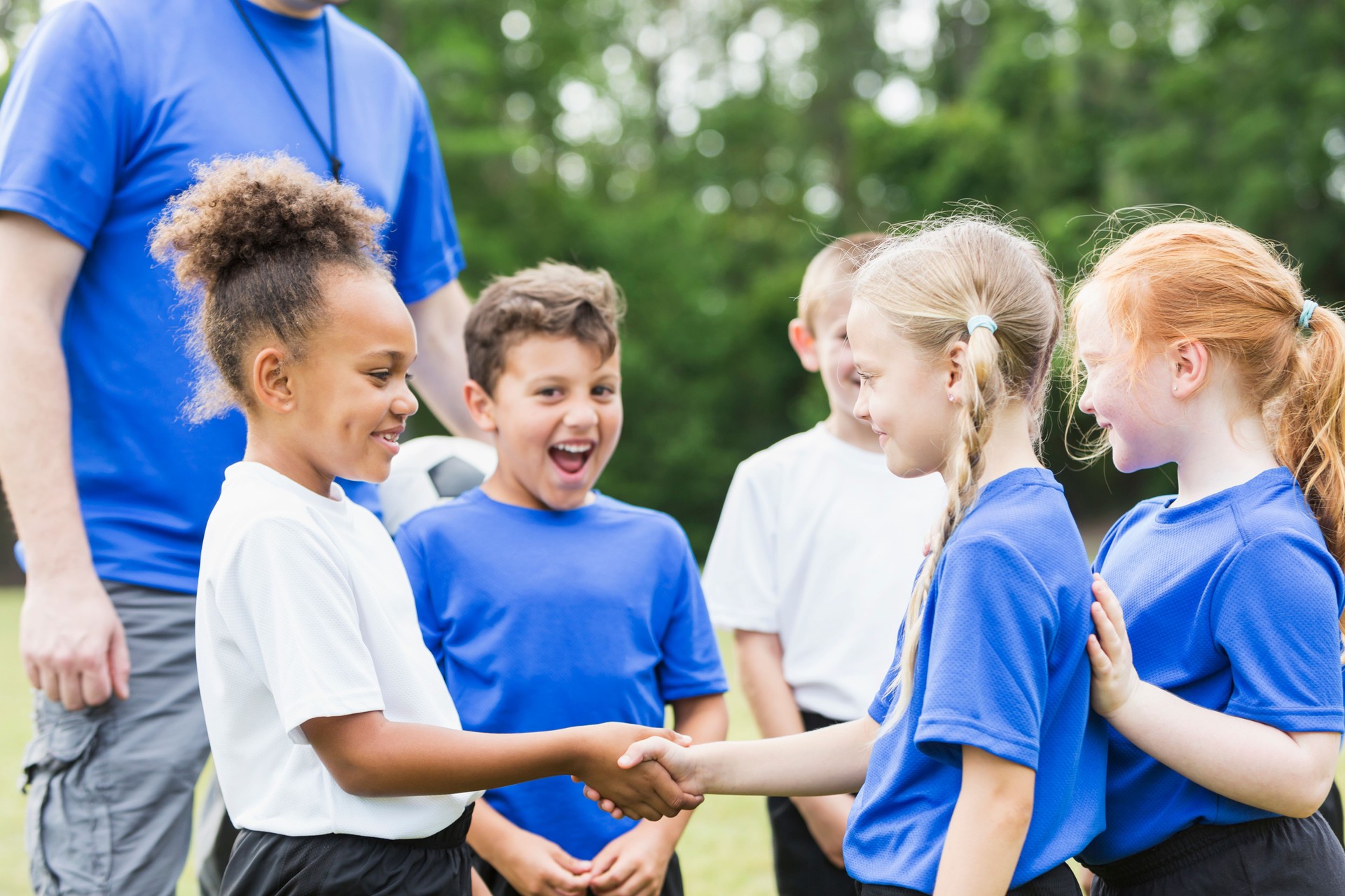 Children's soccer team, girls shaking hands